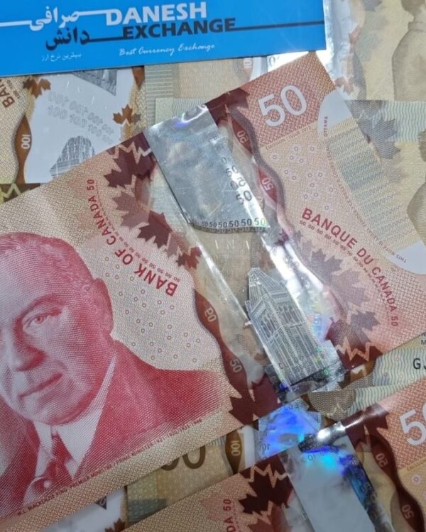 Canadian banknotes in 50‑ and 100‑dollar denominations scattered together Canadian banknotes in 50‑ and 100‑dollar denominations scattered together.