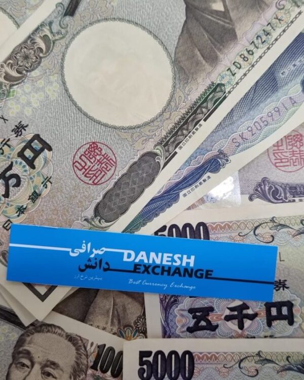 Japanese yen banknotes with a Danesh Exchange label placed on top.