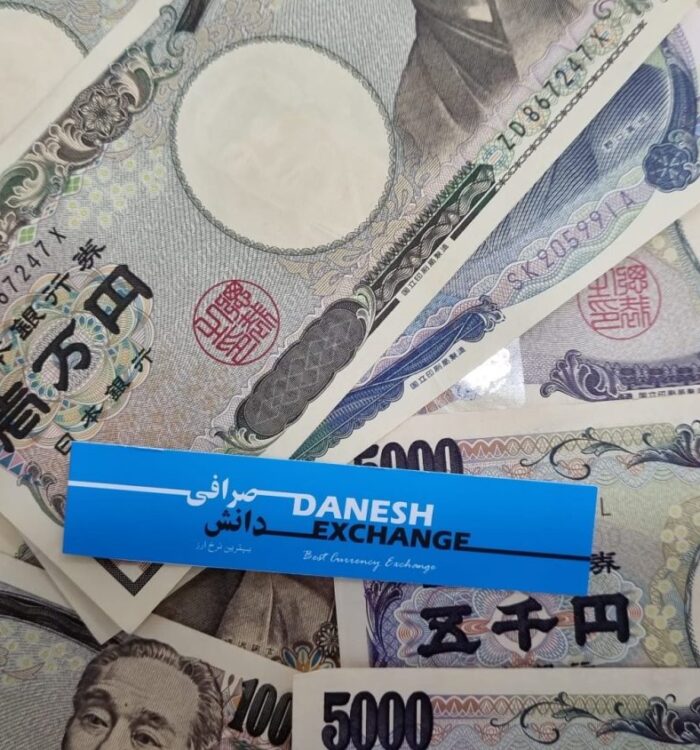 Japanese yen banknotes with a Danesh Exchange label placed on top. Japanese yen banknotes with a Danesh Exchange label placed on top.