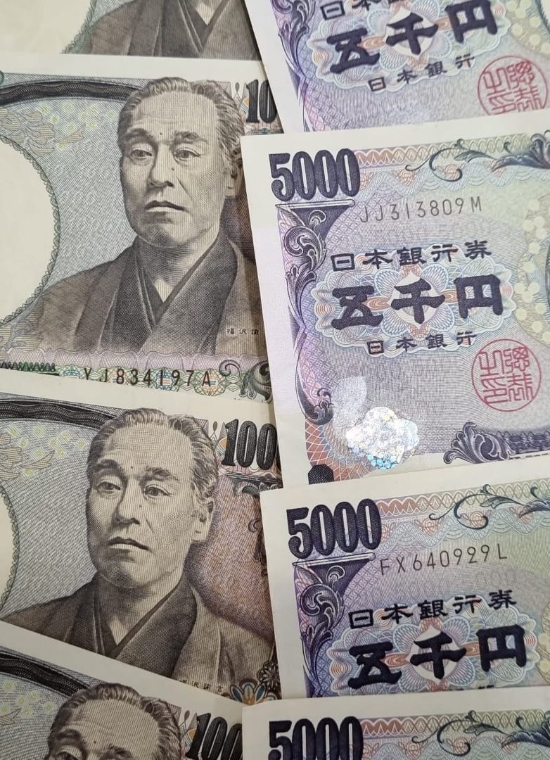 Japanese yen banknotes in 1,000 and 5,000‑yen denominations arranged together. Japanese yen banknotes in 1,000 and 5,000‑yen denominations arranged together.