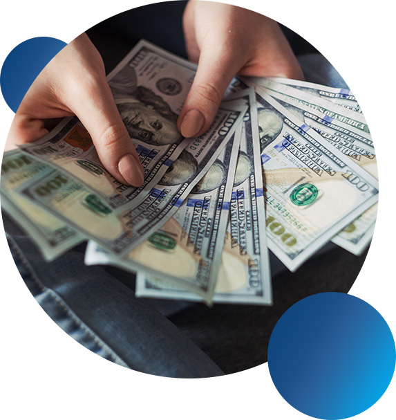 Close‑up of hands displaying crisp US $100 notes in a circular design frame.