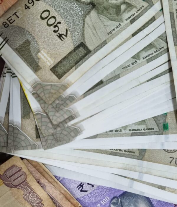 Indian banknotes in 100, 200, and 500‑rupee denominations scattered together. Indian banknotes in 100, 200, and 500‑rupee denominations scattered together.