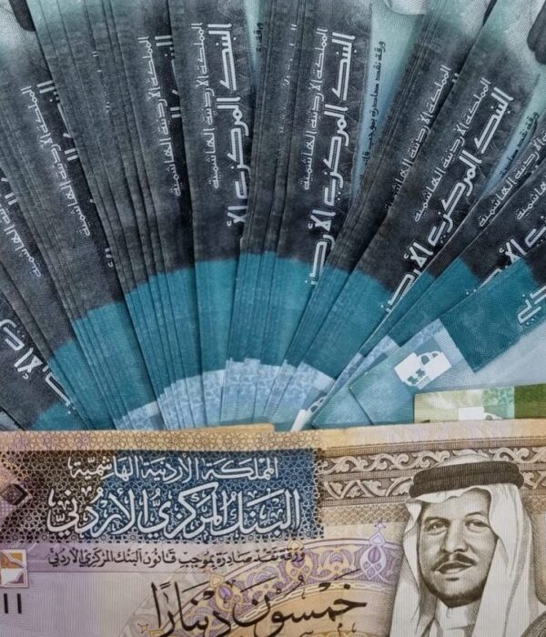 Jordanian dinar banknotes in various denominations arranged in a fan pattern, featuring royal portraits. Jordanian dinar banknotes in various denominations arranged in a fan pattern, featuring royal portraits.