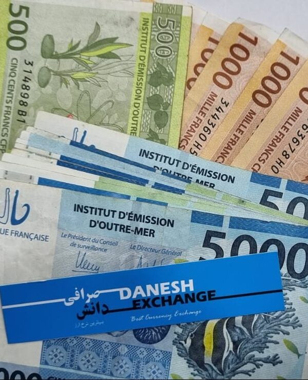 CFP franc banknotes in 500, 1000, and 5000 denominations arranged together with a Danesh Exchange card placed across them. CFP franc banknotes in 500, 1000, and 5000 denominations arranged together with a Danesh Exchange card placed across them.