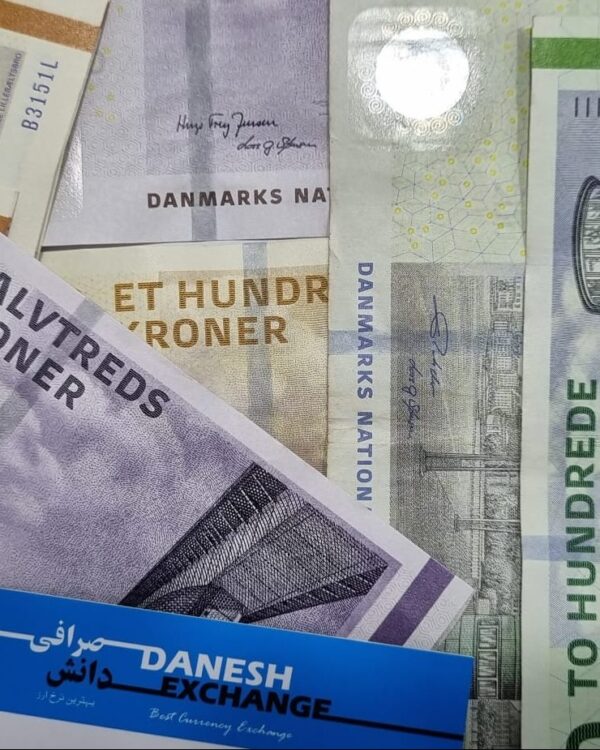 Danish kroner notes in 50, 100, and 200 denominations scattered with Danesh Exchange label..