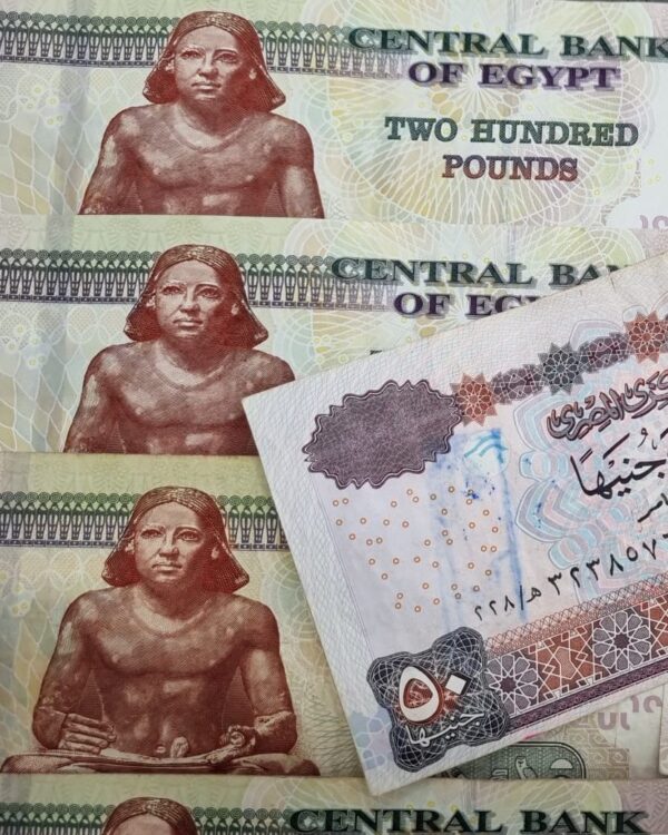 Egyptian 200‑pound banknotes stacked together. Egyptian 200‑pound banknotes stacked together.