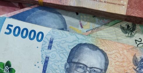 Mixed Indonesian Rupiah notes arranged in a scattered layout. Mixed Indonesian Rupiah notes arranged in a scattered layout.