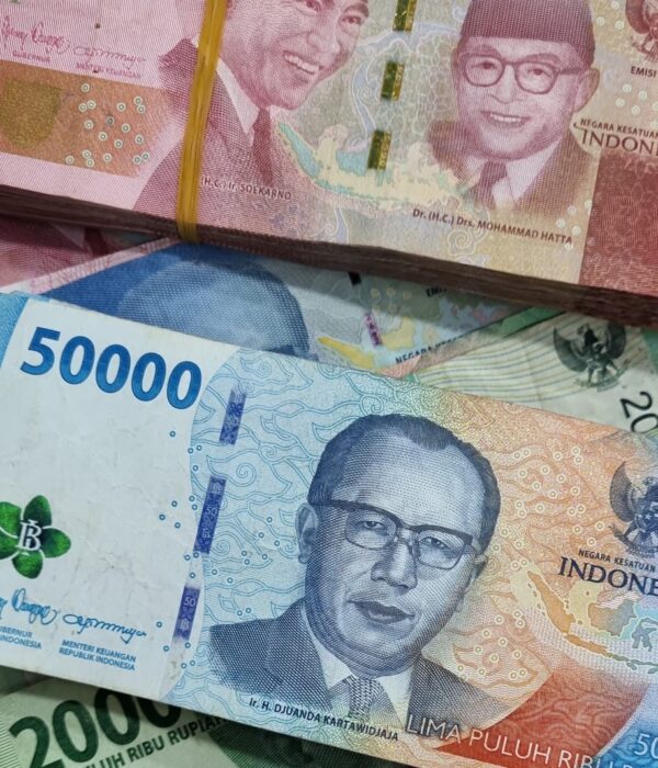 Mixed Indonesian Rupiah notes arranged in a scattered layout. Mixed Indonesian Rupiah notes arranged in a scattered layout.