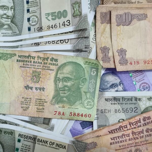 Indian rupee notes in ₹5, ₹10, ₹100, and ₹500 denominations displayed in a scattered layout. Indian rupee notes in ₹5, ₹10, ₹100, and ₹500 denominations displayed in a scattered layout.