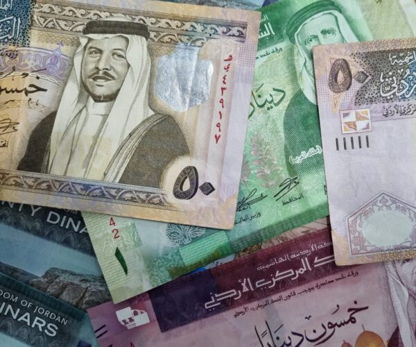 Jordanian 20 and 50 dinar banknotes displayed in a scattered layout. Jordanian 20 and 50 dinar banknotes displayed in a scattered layout.