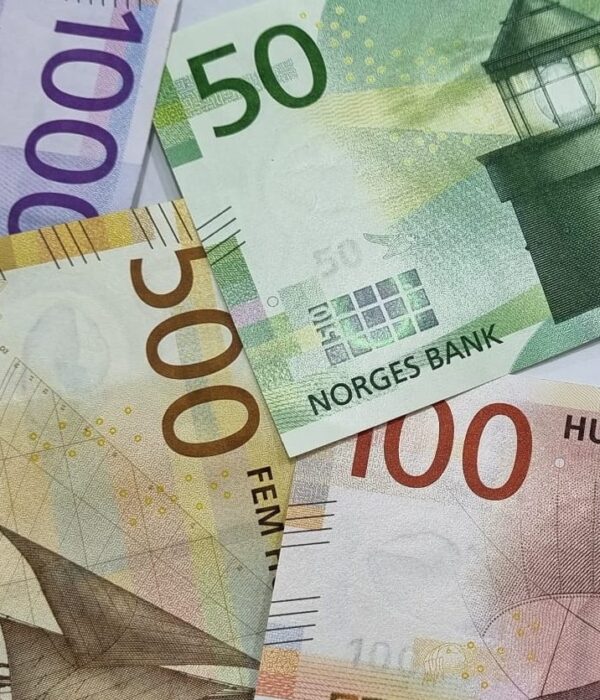 Norwegian kroner banknotes in 50, 100, 500, and 1000 denominations arranged together. Norwegian kroner banknotes in 50, 100, 500, and 1000 denominations arranged together.