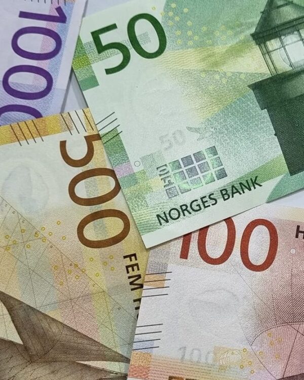 Norwegian kroner banknotes in 50, 100, 500, and 1000 denominations arranged together. Norwegian kroner banknotes in 50, 100, 500, and 1000 denominations arranged together.