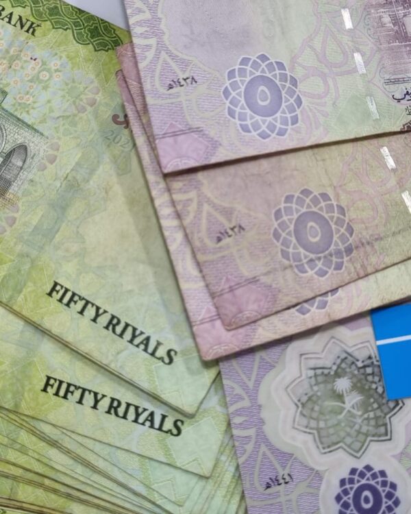 Saudi fifty‑riyal banknotes arranged side by side, showing colourful designs and Arabic script, with a blue Danesh Exchange label placed among them. Saudi fifty‑riyal banknotes arranged side by side, showing colourful designs and Arabic script, with a blue Danesh Exchange label placed among them.