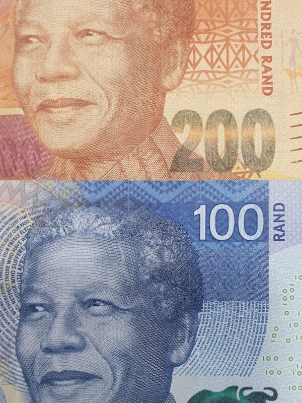 South African rand banknotes in 100 and 200 denominations featuring Nelson Mandela, displayed in a close-up layout commonly used for currency exchange and forex services. South African rand banknotes in 100 and 200 denominations featuring Nelson Mandela, displayed in a close-up layout commonly used for currency exchange and forex services.