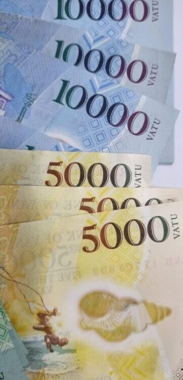 Multiple 5000 Vatu and 10000 banknotes from Vanuatu arranged in a close-up layout. Multiple 5000 Vatu and 10000 banknotes from Vanuatu arranged in a close-up layout.