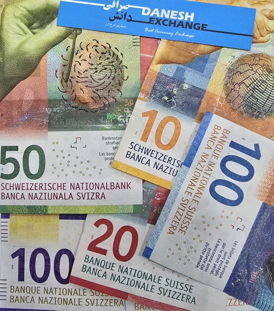 Swiss banknotes in 10, 20, 50, and 100 franc denominations arranged together with a Danesh Exchange card placed above them. Swiss banknotes in 10, 20, 50, and 100 franc denominations arranged together with a Danesh Exchange card placed above them.