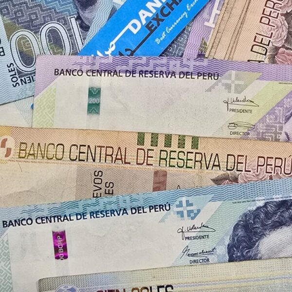 Peruvian 100 and 200 soles banknotes arranged together in overlay. Peruvian 100 and 200 soles banknotes arranged together in overlay.