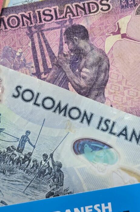 Solomon Islands banknotes, including a prominent 100‑dollar note with traditional cultural illustrations, arranged together above a blue Danesh Exchange label. Solomon Islands banknotes, including a prominent 100‑dollar note with traditional cultural illustrations, arranged together above a blue Danesh Exchange label.