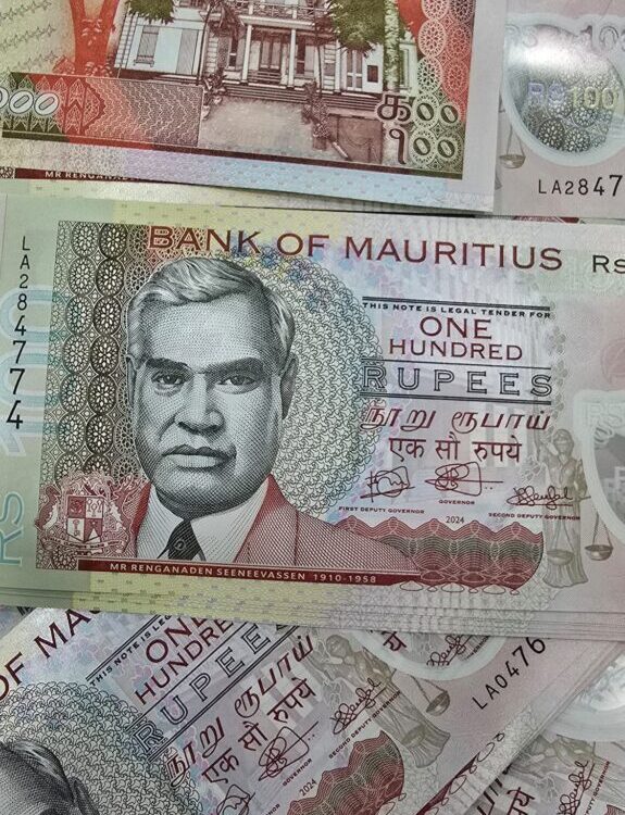 Mauritian banknotes, including several 100‑rupee notes, arranged together with detailed portraits, security patterns, and building illustrations. Mauritian banknotes, including several 100‑rupee notes, arranged together with detailed portraits, security patterns, and building illustrations.